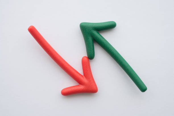 Red and green arrow on opposite different direction on white background. Choosing or decision in business, financial and investment concept.