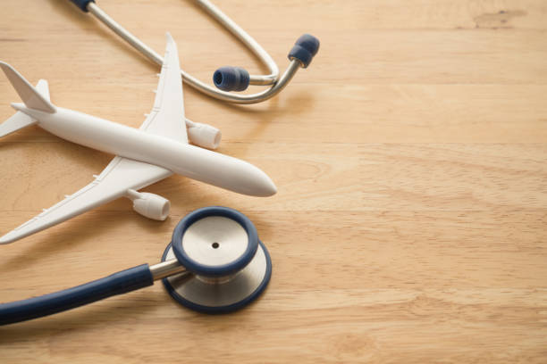 istock Airplane and stethoscope on wooden background. 1617843385