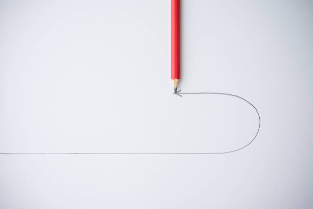 istock Flat lay of red pencil draw turning point arrow line on white background. 1617848576