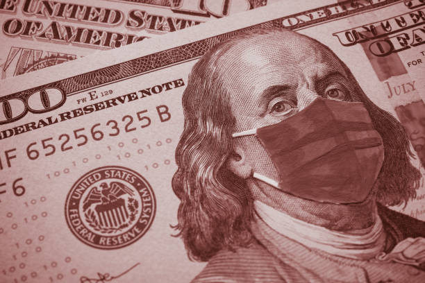istock Benjamin Franklin president wear face mask on US dollar bill banknote background. 1617862792