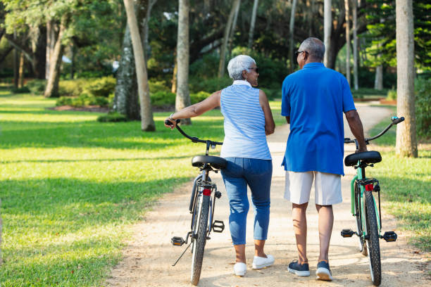 istock Senior African American couple walking with bikes 1617863346