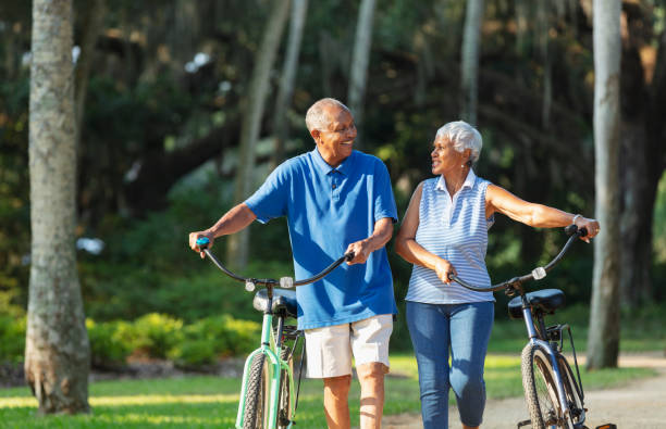 istock Senior African American couple walking with bikes 1617864078