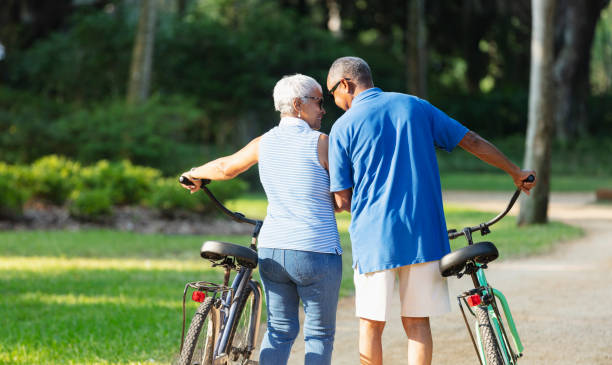 istock Senior African American couple walking with bikes 1617864127