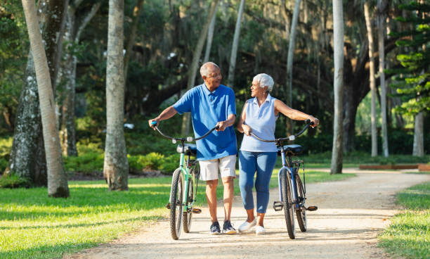 istock Senior African American couple walking with bikes 1617864276