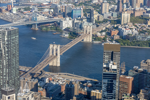 A view of New York City from the One World Observatory, including the Brooklyn and Manhattan Bridges and the East River.