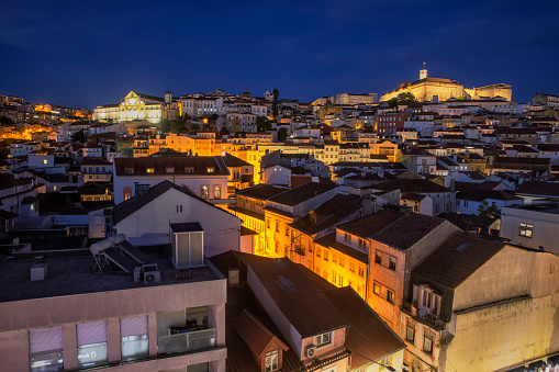 An aerial view of city skyline in Coimbra at blue hour.