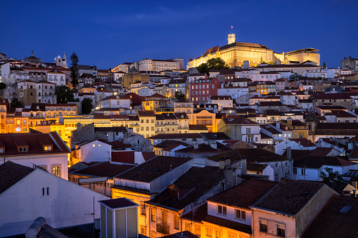 An aerial view of city skyline in Coimbra at blue hour.