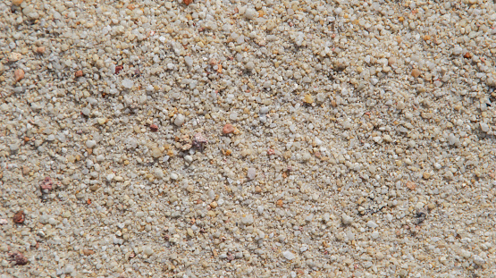 Beach coarse white sand texture and backdrop.