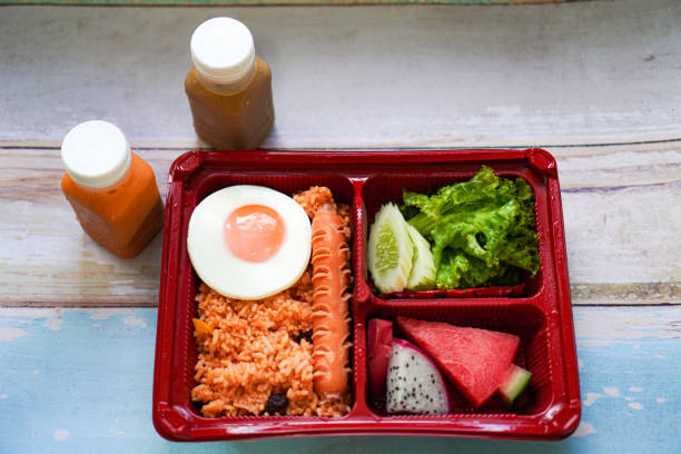 istock The picture shows a home-made bento set menu that includes American fried rice, fried egg, fresh fruit and ready-to-drink iced coffee. 1617911550