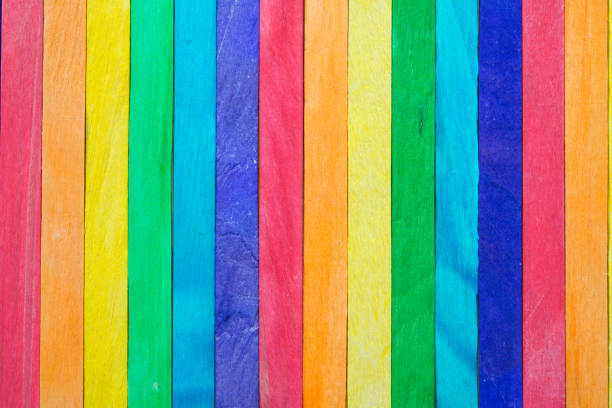 istock Colored painted wood like a LGBT pride flag background with copy space. 1617917864
