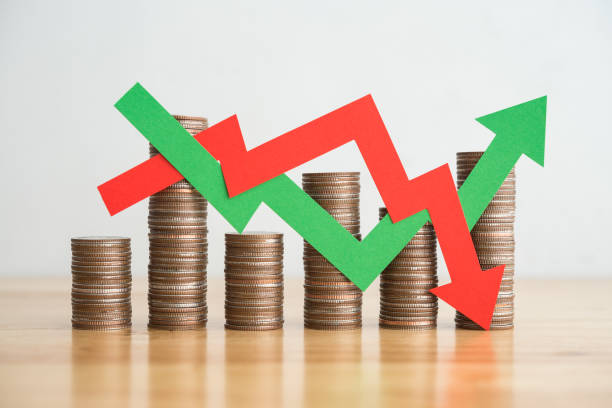 Stack coins and arrow red green graph chart volatility swing up and down.