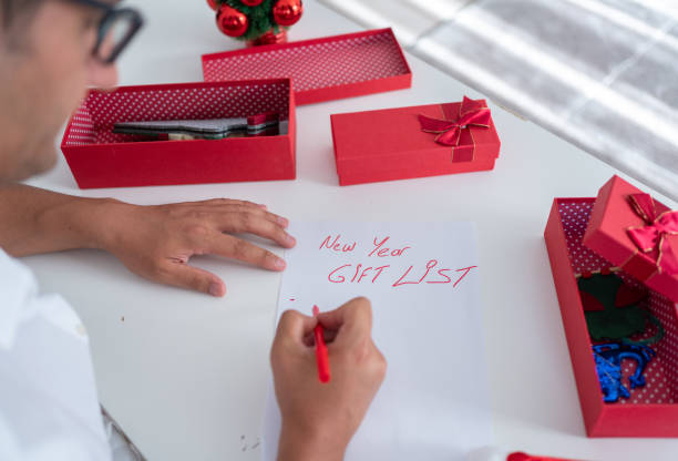 istock Man Prepares Christmas Gift List 1617938944