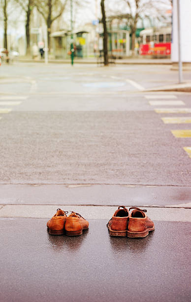 istock Old shoes on sidewalk 161793932