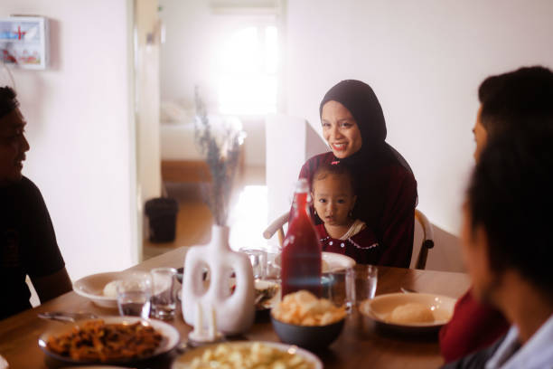 istock Happy Indonesian Family Gather at Dinner Table 1617940875