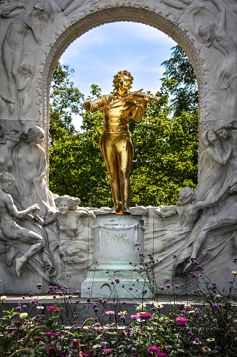 Vienna, Austria - April 9, 2012: Sculpture in front of Albertina museum in Vienna. It was part of Hofburg imperial palace and now it houses one of the largest and most important print rooms in the world. It is located in central Vienna. On this photo is terrace of museum where many people rest and look at the opera across the street.