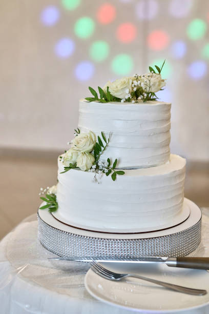 istock A beautiful weA beautiful wedding cake decorated with fresh roses. Wedding celebration.dding cake decorated with fresh roses. Wedding celebration. 1617942589