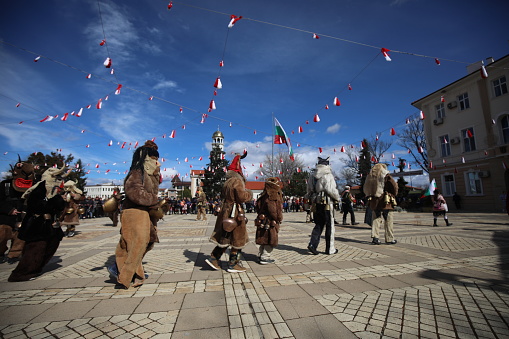 Elin Pelin, Bulgaria - March 11, 2023: Masquerade festival in Elin Pelin, Bulgaria. People with mask called Kukeri dance and perform to scare the evil spirits.