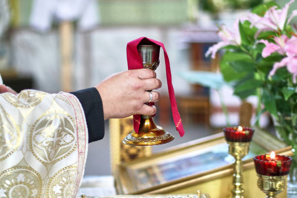 istock During the service, the priest raises the cup with wine. Religion. Eucharist. 1617942838