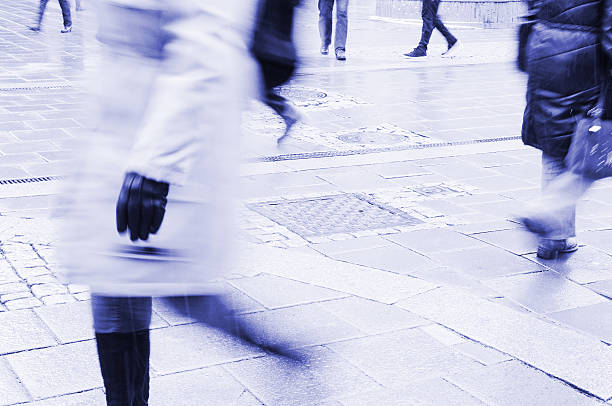 istock Motion blurred pedestrians with bags on city square 161794302