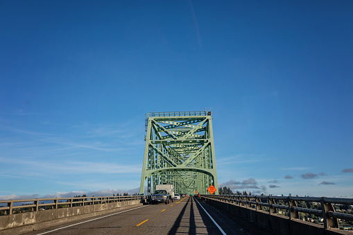 Astoria, United States - August 7, 2023. Traffic crosses the Astoria–Megler Bridge returning from the state of Oregon into the state of Washington.