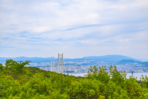 The Akashi Kaikyo Bridge is one of the most impressive suspension bridges in the world, connecting Honshu and Awaji Island in Japan. It spans a total length of approximately 3,911 meters, with its central span measuring an astounding 1,991 meters. While it was once recognized as the suspension bridge with the longest central span in the world, it currently holds the position of the second longest. The bridge's illumination at night captivates numerous tourists with its beauty. Furthermore, the bridge suffered damage during the 1995 Great Hanshin-Awaji Earthquake, but the subsequent repair efforts are celebrated as a testament to technological advancements and a symbol of Japan's resilience and recovery.