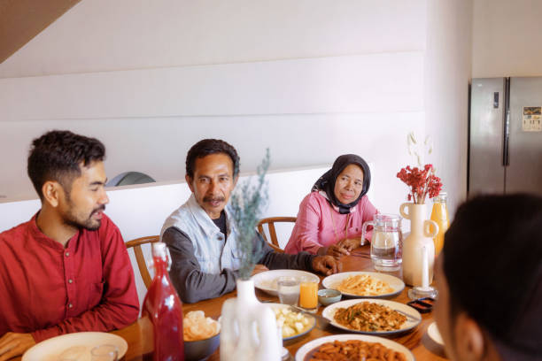 istock Indonesian Family Gather at Dinner Table Chatting 1617954623