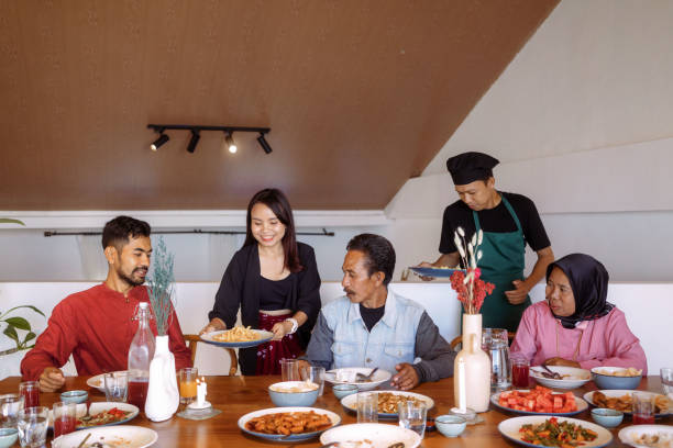 istock Family Sharing Food at Dinner Table 1617960449