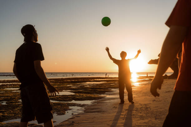 istock Indonesian Playing Catch Ball at the Beach during Sunset 1617976460