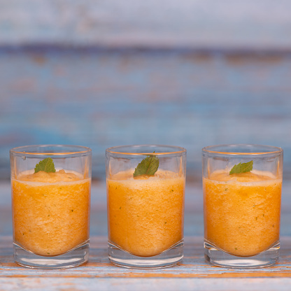 Delicious Bowl of tasty melon sorbet, melon and mint leaf verrine, High quality photo
