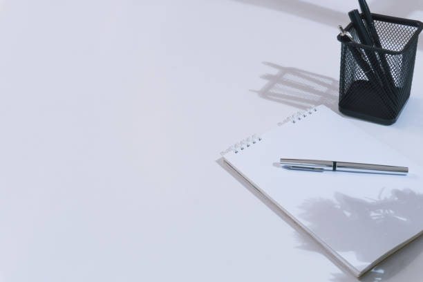 istock White office desk with shadows on the desk 1618044586