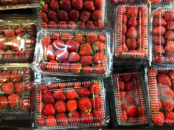 istock Pile of red strawberries in plastic bag or container 1618076495