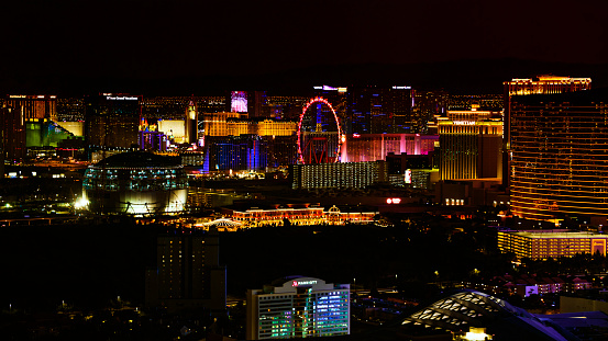 Las Vegas, Nevada/ USA - March 14, 2022: Aerial view of High Roller and surrounding hotels at night.\n\nLas Vegas is the largest city in the US state of Nevada and a world-renowned center for gambling, shopping, fine dining and entertainment. It is mainly famous for its many casinos and the accompanying entertainment-tourism activities, which earned it the nickname of the Entertainment Capital of the World.