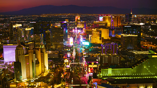 Las Vegas, Nevada/ USA - March 14, 2022: Aerial view of hotels along The Strip in Las Vegas at night.

Las Vegas is the largest city in the US state of Nevada and a world-renowned center for gambling, shopping, fine dining and entertainment. It is mainly famous for its many casinos and the accompanying entertainment-tourism activities, which earned it the nickname of the Entertainment Capital of the World.