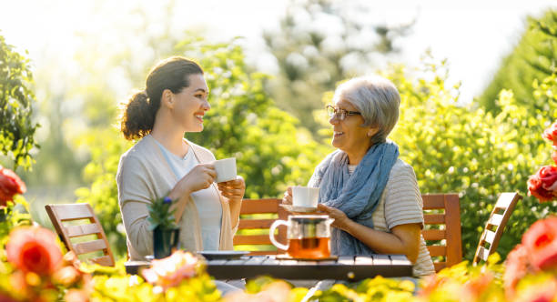istock women drinking tea in the garden 1618085655
