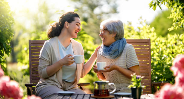 istock women drinking tea in the garden 1618088289