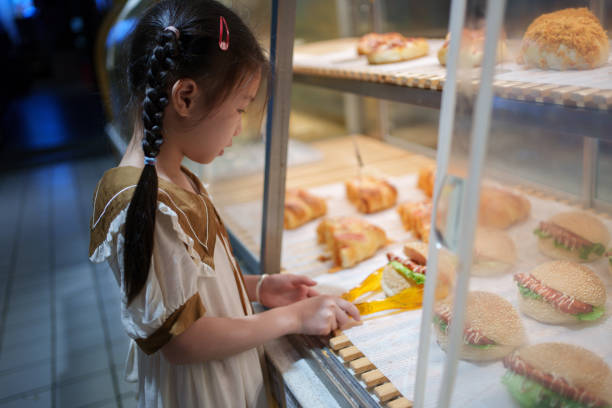 istock little girl buying a hamburger 1618089826