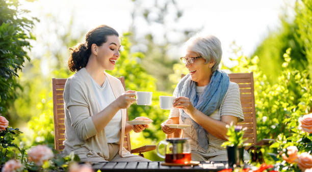 istock women drinking tea in the garden 1618090033
