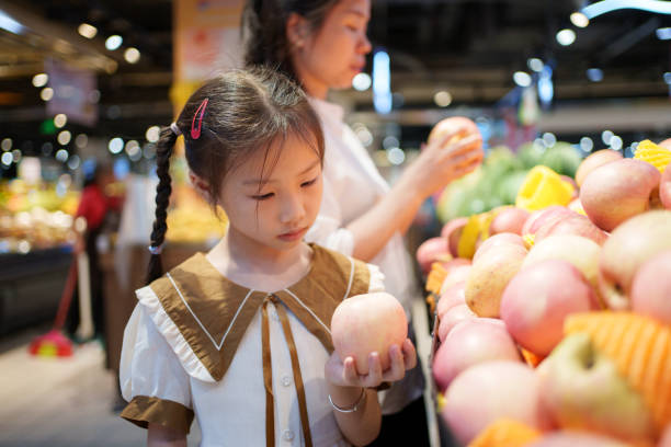 istock little girl holding an apple 1618098465
