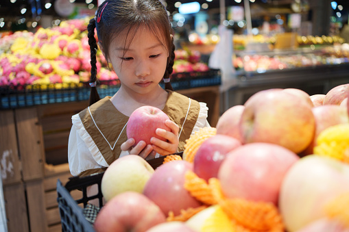little girl picking apples