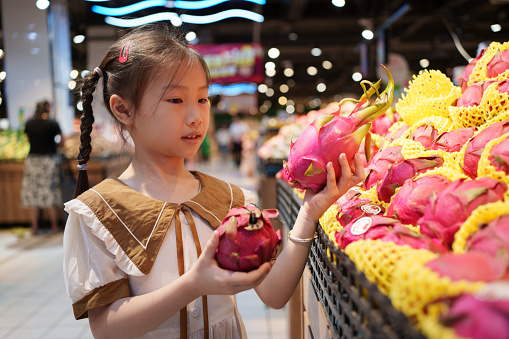 little girl picking dragon fruit