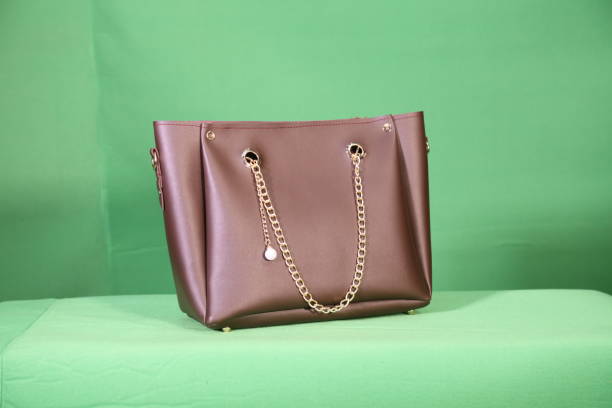 istock Ladies brown colour hand bag with chain 1618099532