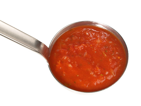 Tomato Soup in a Soup Ladle on white Background