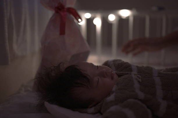 istock sleeping kid with present of cristmas 1618102203