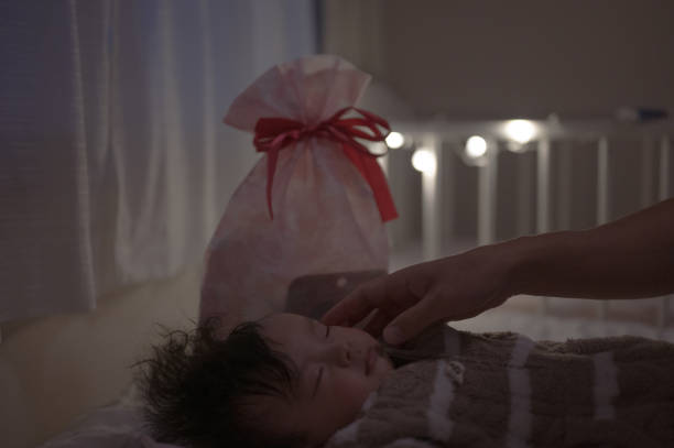 istock sleeping kid with present of cristmas 1618102737