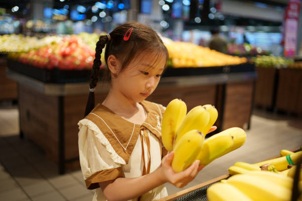 istock child holding banana 1618103288