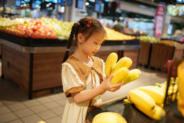 istock child holding banana 1618103319