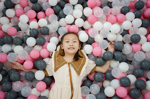 little girl in the sea of ​​balls
