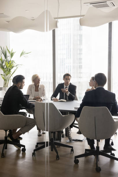 istock Young boss, CEO, executive speaking to managers on team meeting 1618131026