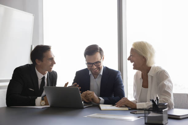 istock Positive small business team brainstorming at laptop 1618131379