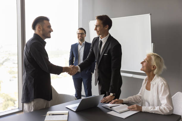 istock Boss expressing recognition to best manager, employee, giving handshake 1618131619